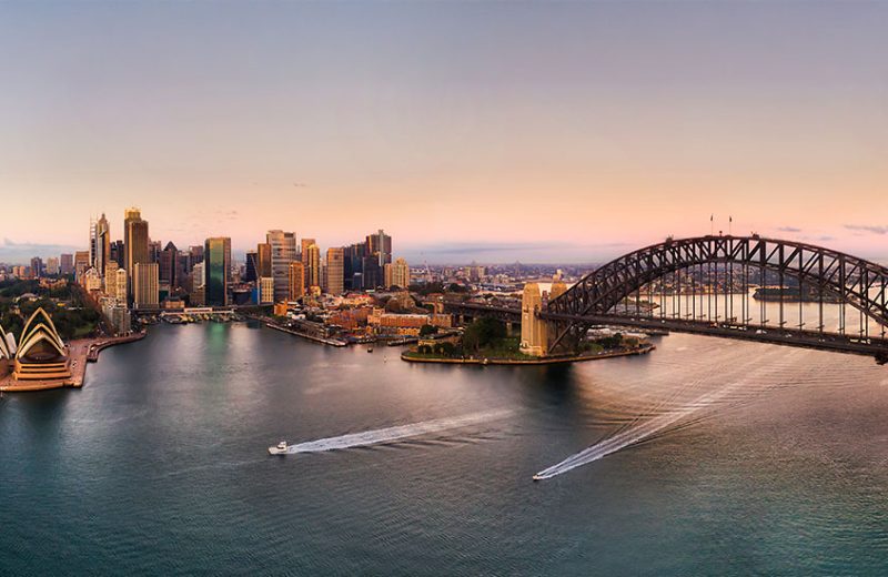 Aerial view of Sydney Harbour bathed in golden hues